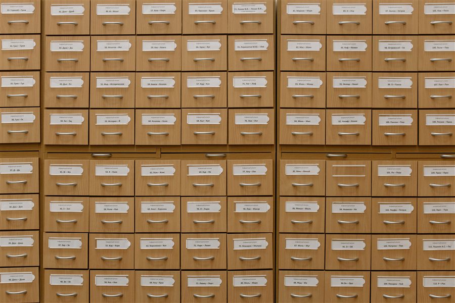 Research consultation with archival card catalog